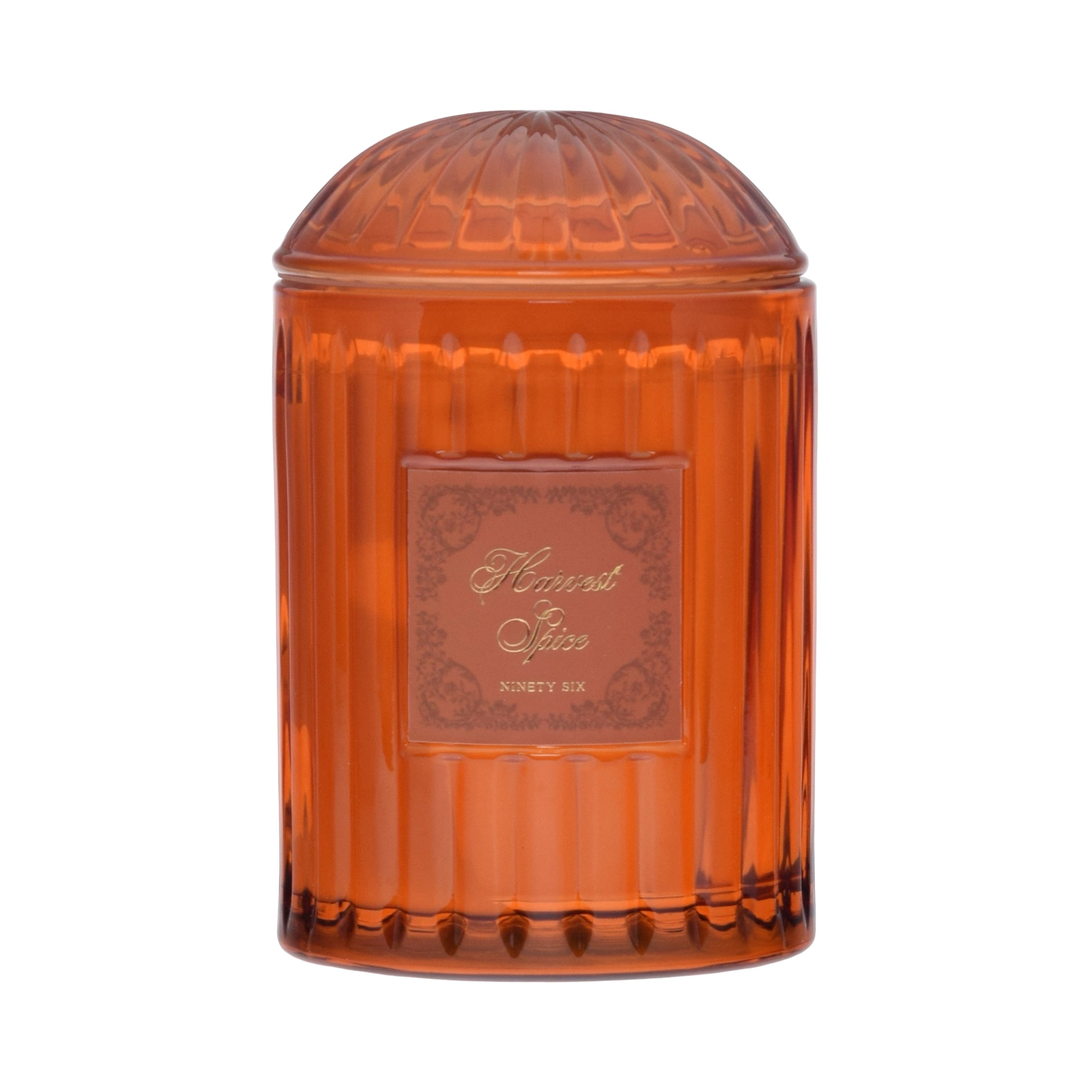 Orange glass jar with decorative label on a orange background