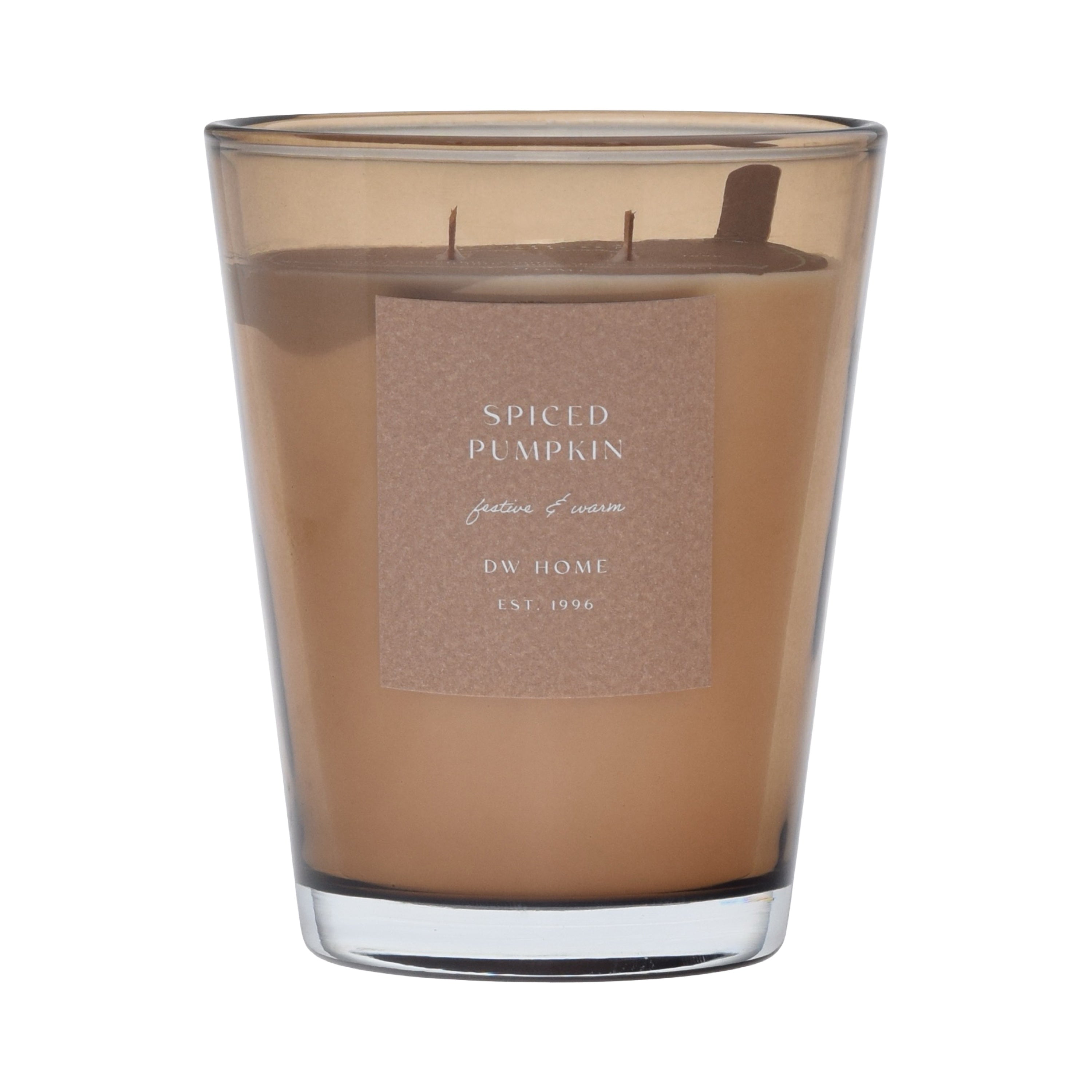 Brown vase candle in a glass container with a label on a brown background