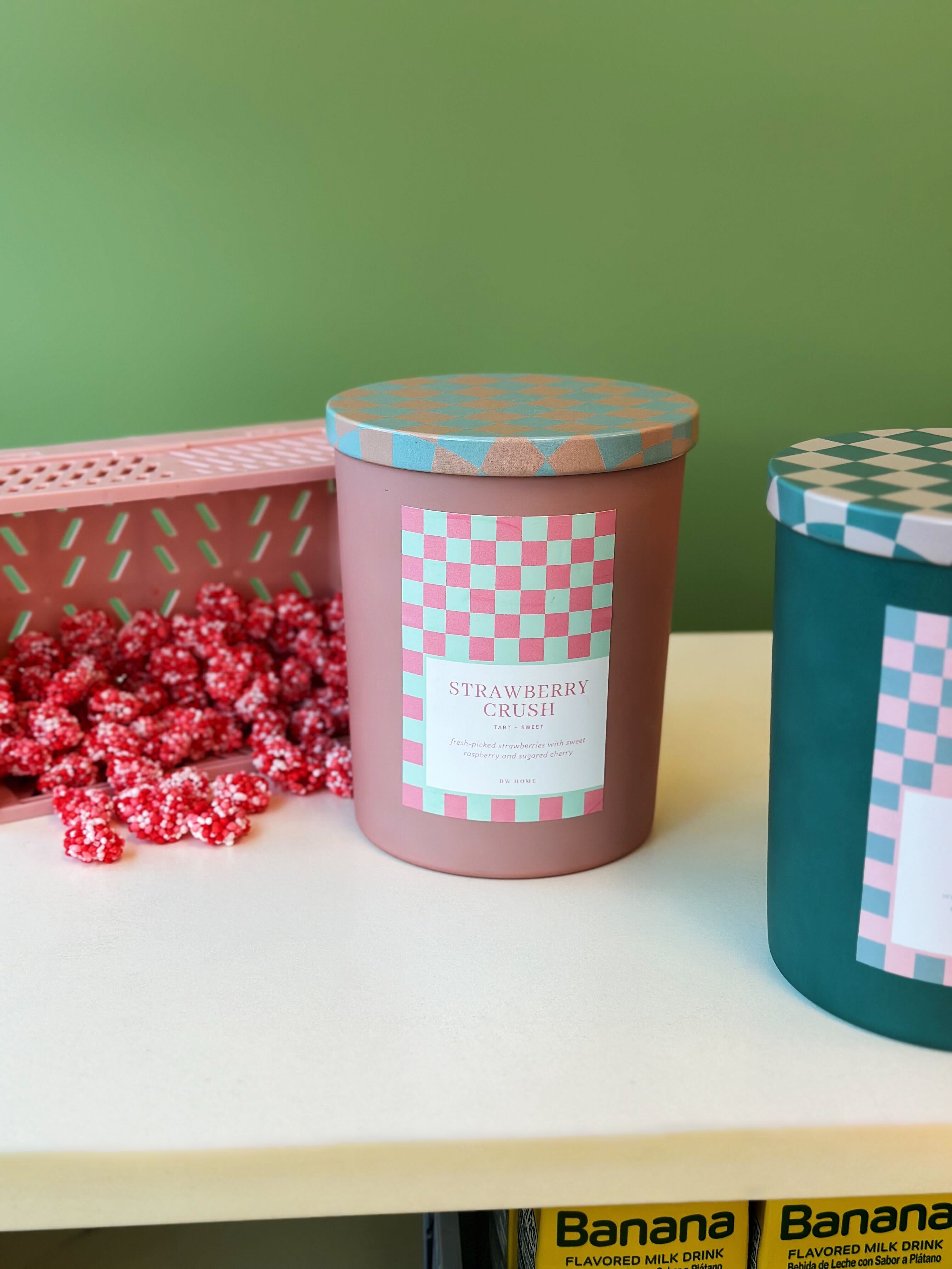 A group of candles filled with DW Home Strawberry Crush candy sit on the table.